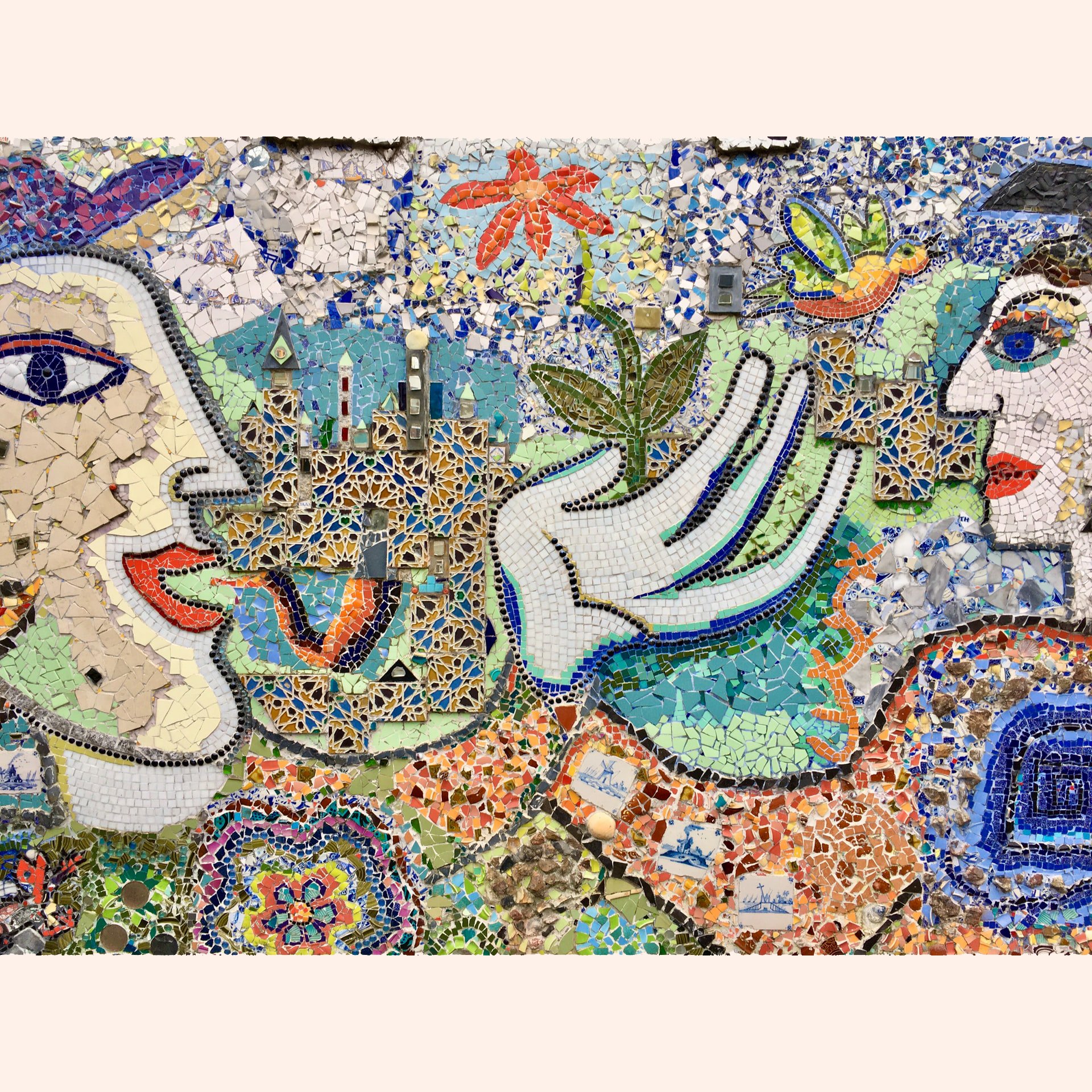Photo by Giulia May on Unsplash. Photo of colorful mosaicwith two people talking, one person extending hand.